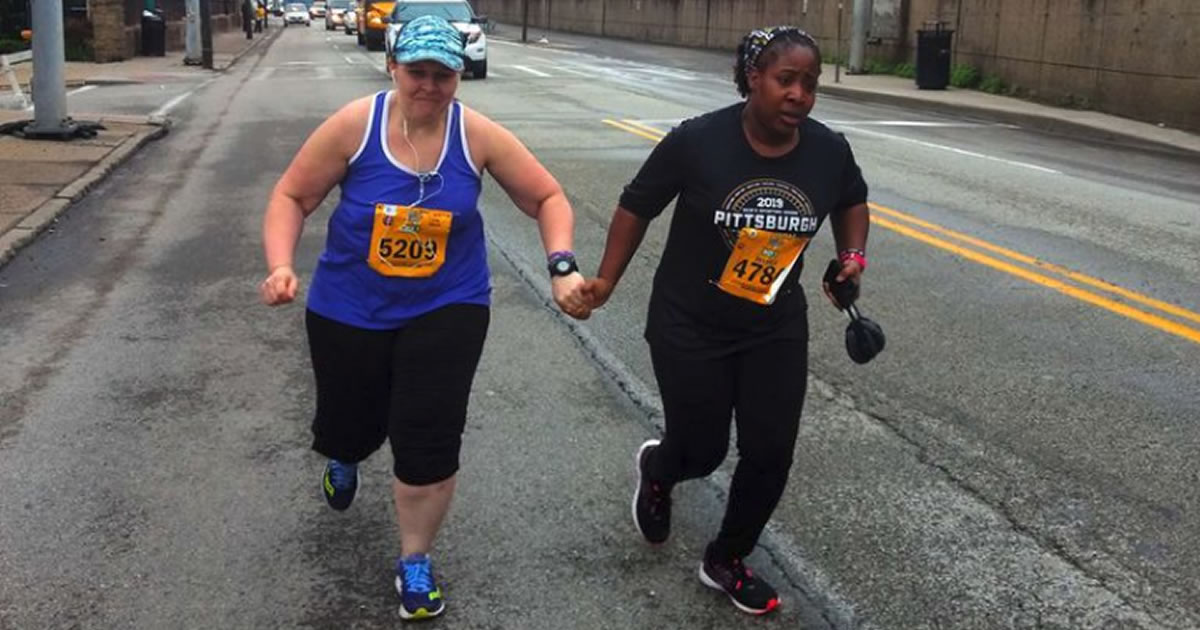 Marathon runner Daniel Heckert captured this image of Laura Mazur and Jessica Robertson holding hands as they ran the Pittsburgh Marathon