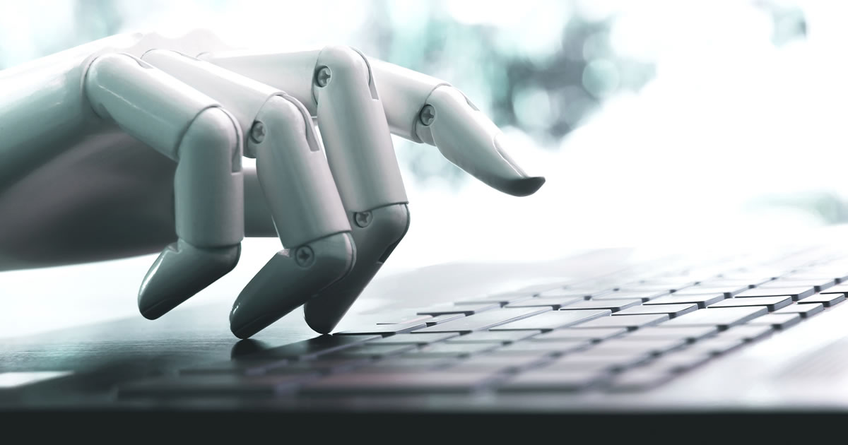Robot hand on computer keyboard