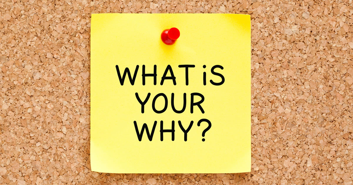 What is your why question handwritten on yellow sticky note pinned on cork bulletin board
