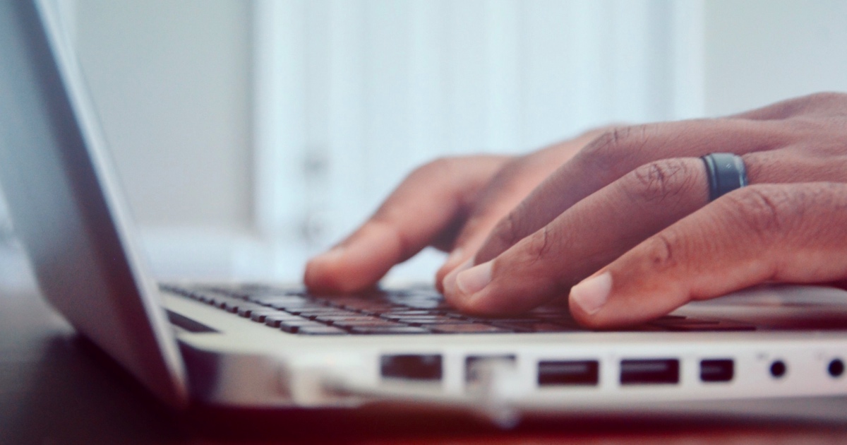 Man typing on laptop