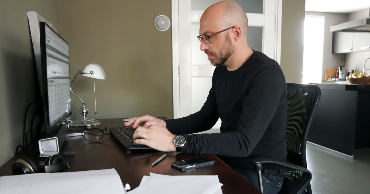 Man using computer at home desk