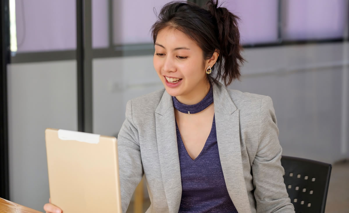 Female writer on client video chat, working from home office