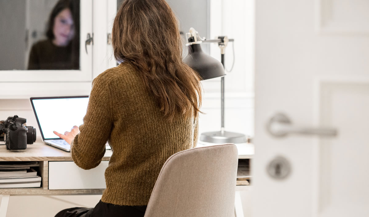 Woman working on laptop at desk