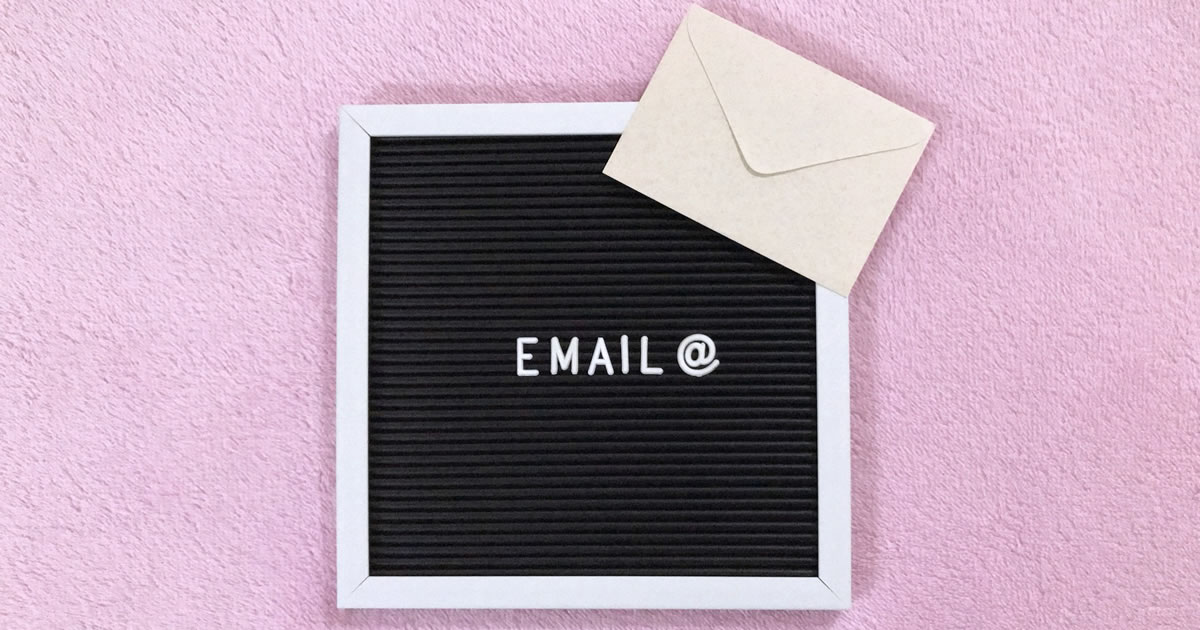 Envelope next to letterboard sign spelling out the the word email