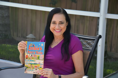 Photo of copywriter Susan with the Archie Comics issue that launched her writing career at age 9