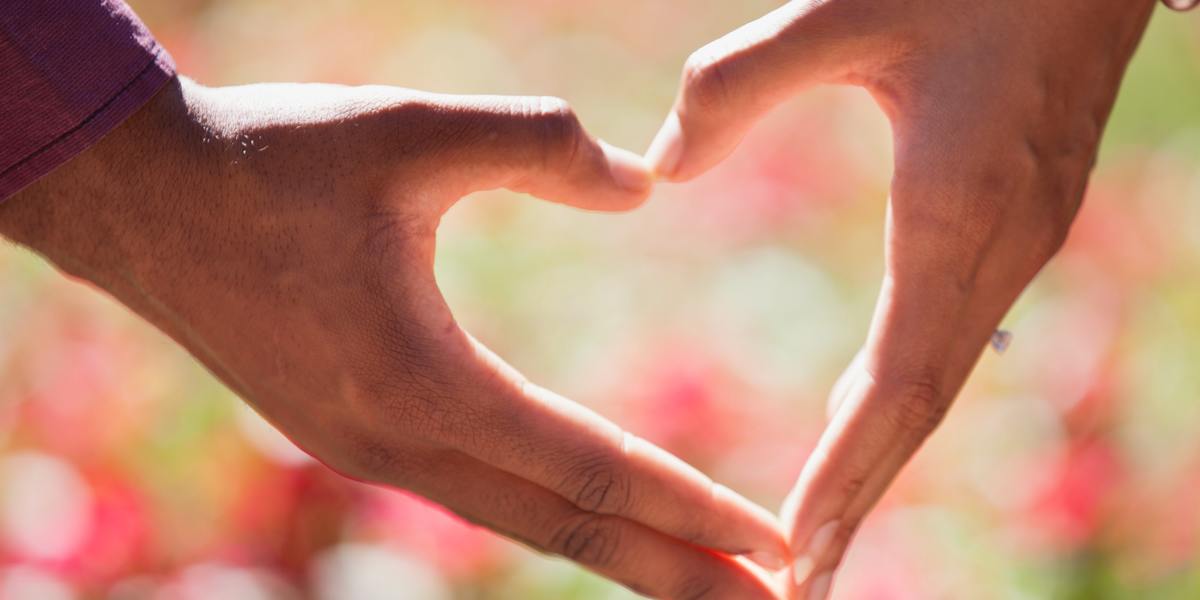 Two hands together forming a heart shape