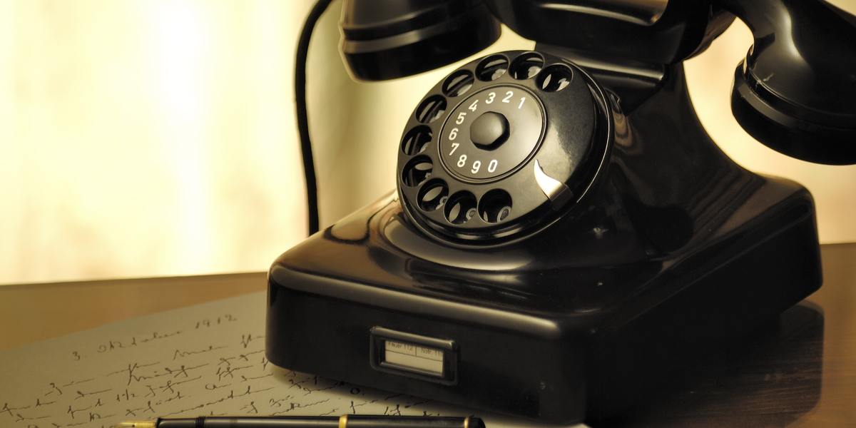 Vintage black rotary telephone on table