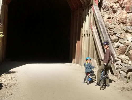 Photo of writer Zoe Blarowski biking the Myra Canyon Trestles near Kelowna