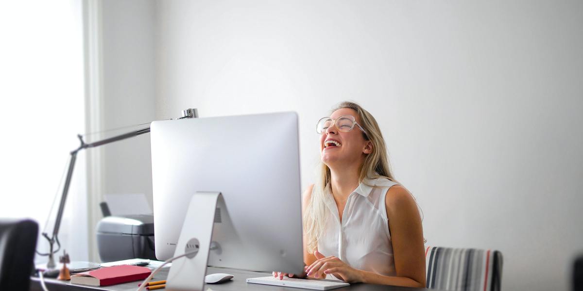 Woman having fun and smiling virtually talking to someone on computer