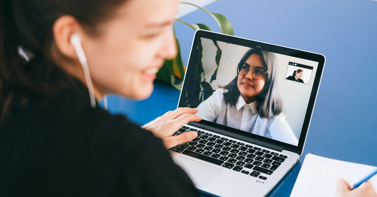 Young woman on a laptop video call with a female client