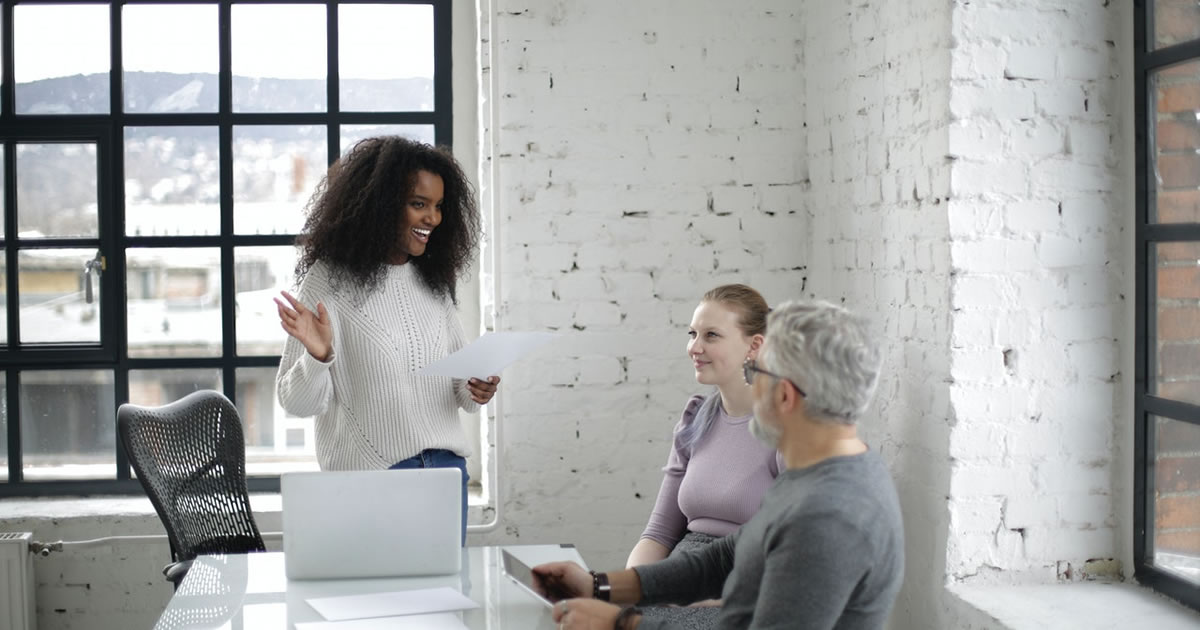 Cheerful colleagues discussing a marketing campaign together