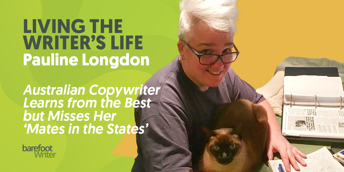 Writer Pauline Longdon at her desk with her cat Bailey