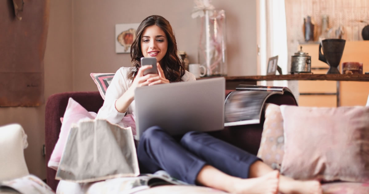 Woman writer using mobile device and laptop