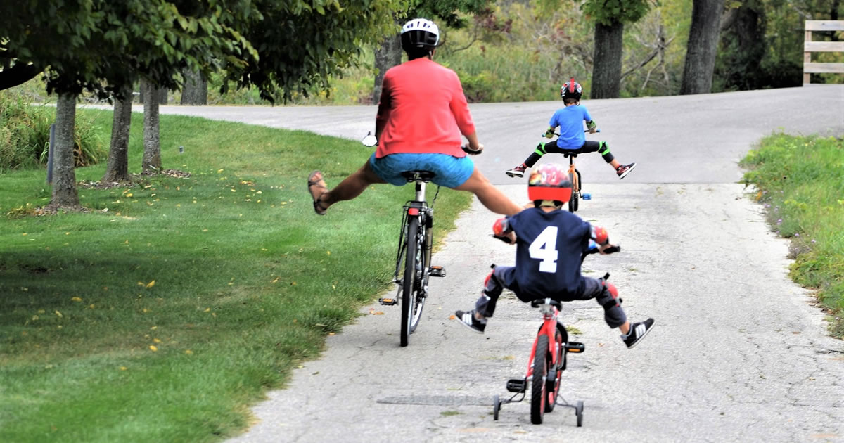 Woman and two kids enjoying a bike ride together