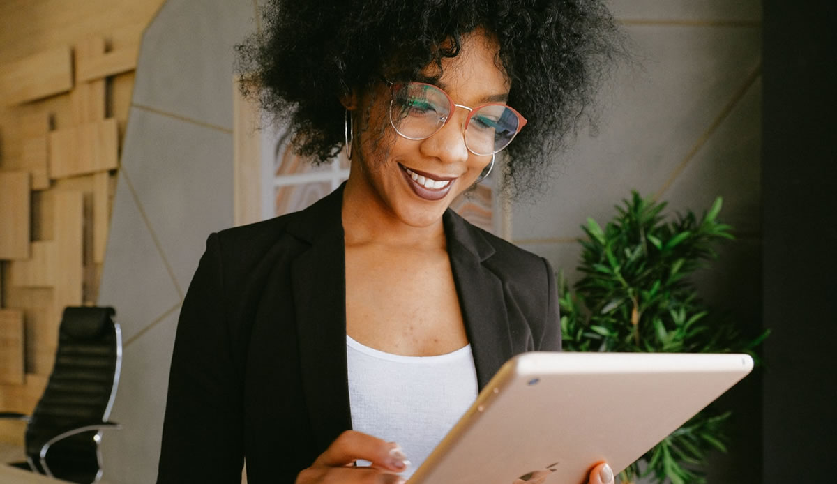 happy female writer checking out work on an iPad