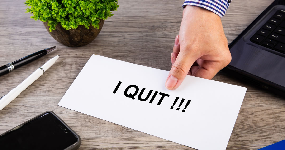 Resignation letter being placed on the desk of the boss