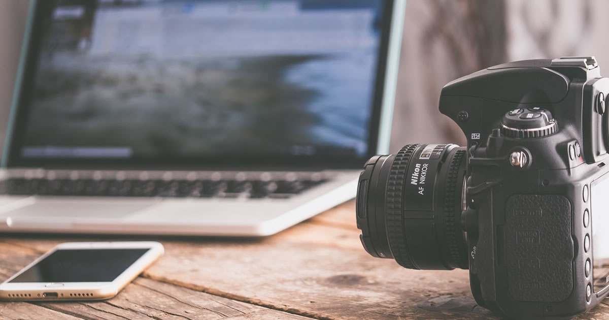 camera and laptop on a desk