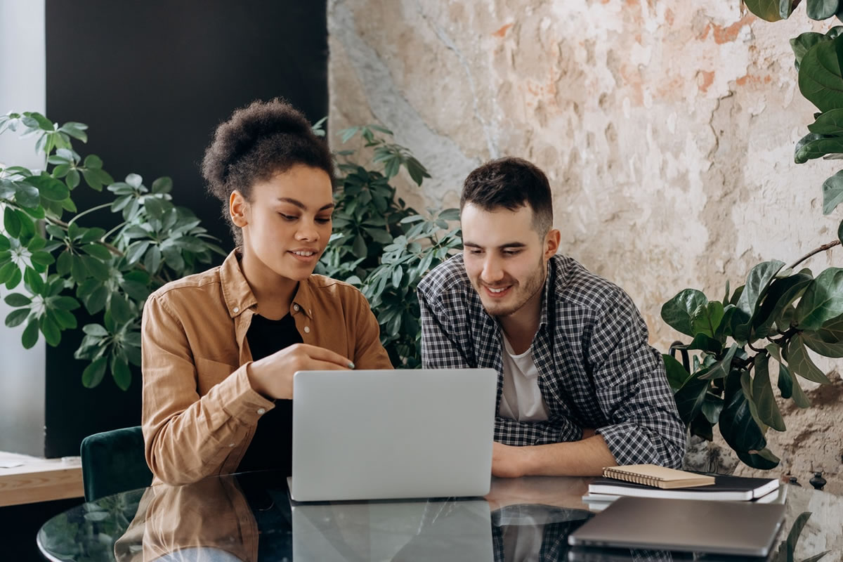 Couple at a table working on a laptop