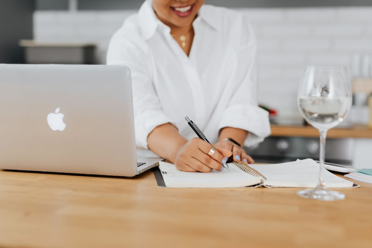 Woman at a table taking notes