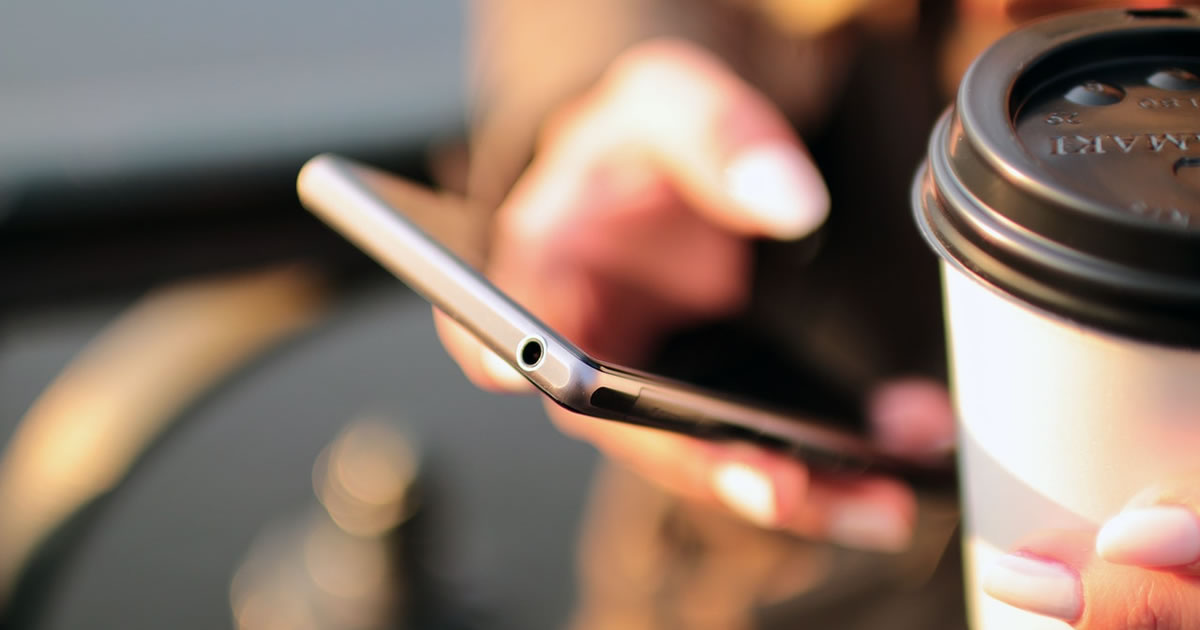 Woman holding smartphone scrolling website