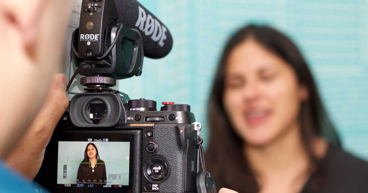 Video camera recording a woman speaking