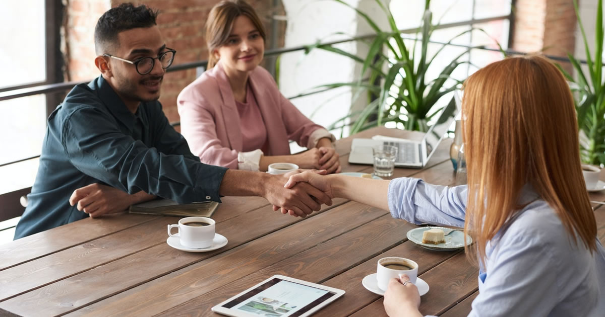 business associates shaking hands at meeting