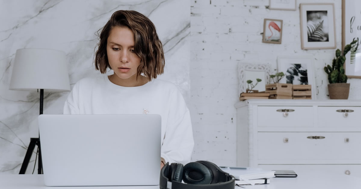 female freelance writer working on her laptop in a home office