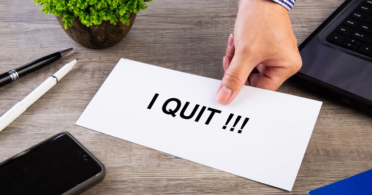 Resignation letter being placed on the desk of the boss