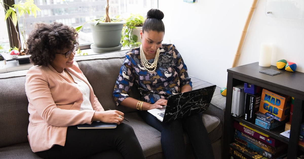 Two women looking at a laptop