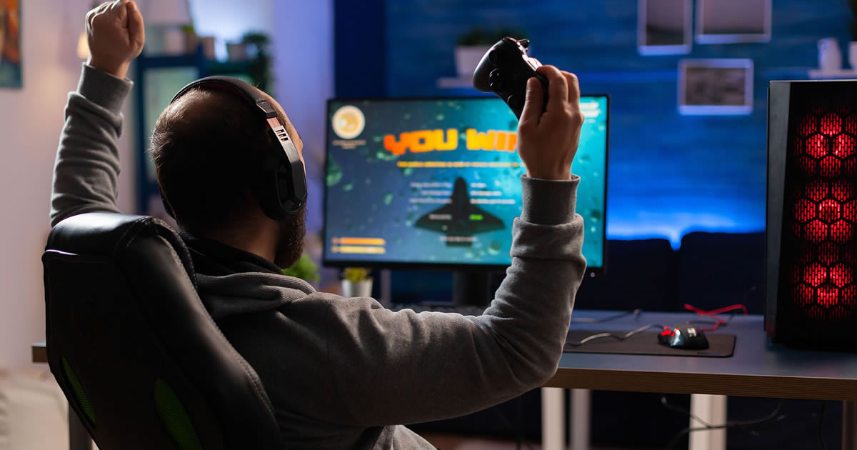 Man sitting at computer playing a video game