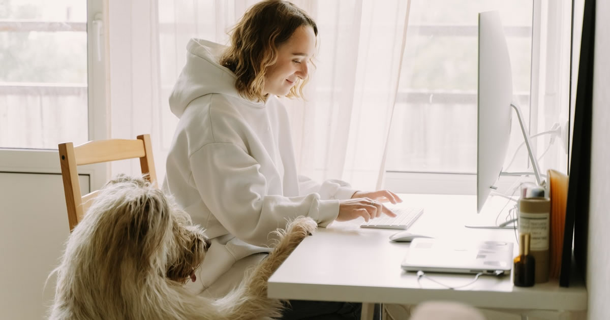 Female freelance writer working on computer in home office