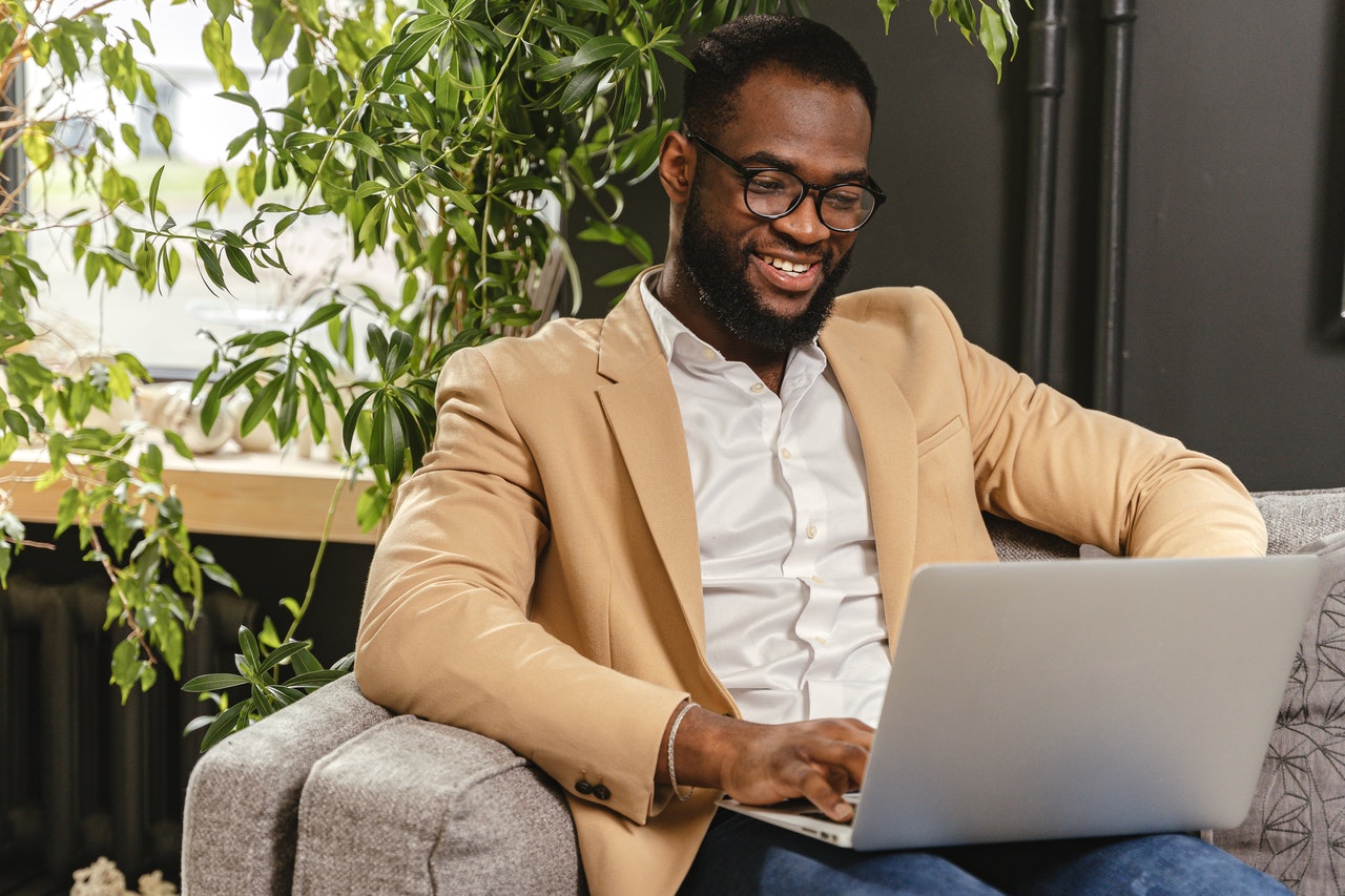 Man sitting on a sofa with a laptop