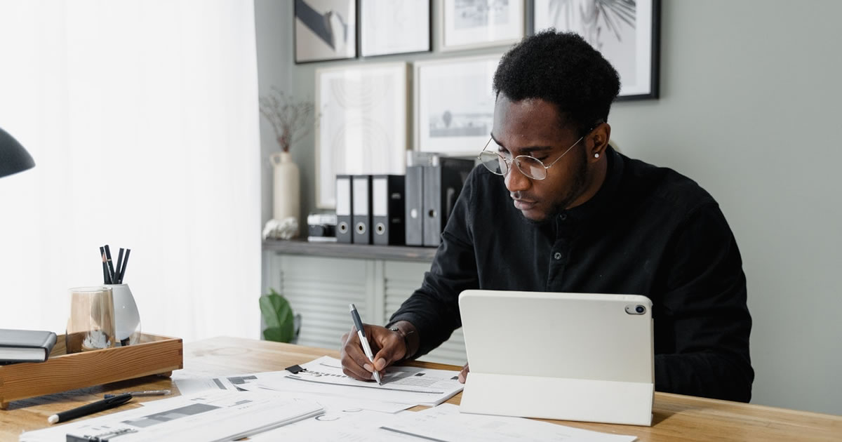 freelance male writer working on files at desk