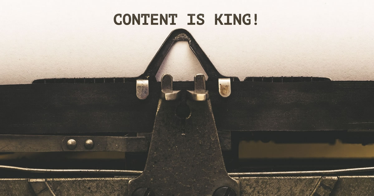 Paper in typewriter with the words CONTENT IS KING!