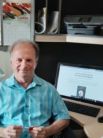 Writer Craig Grossman sitting at his desk