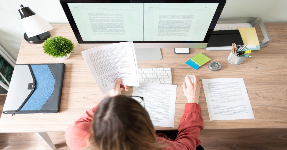 Female freelance copyeditor working on computer at desk