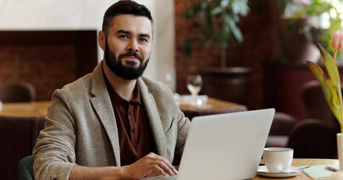 Man smiling working on emails