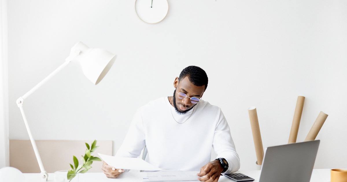 writer sitting at a desk looking at papers