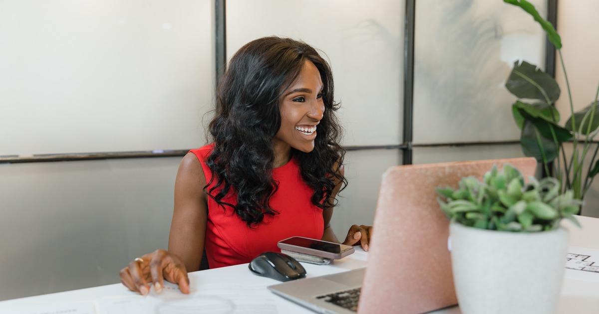 Writer smiling looking at laptop