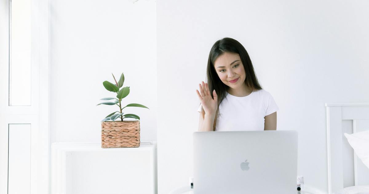 Writer on a call waving hello