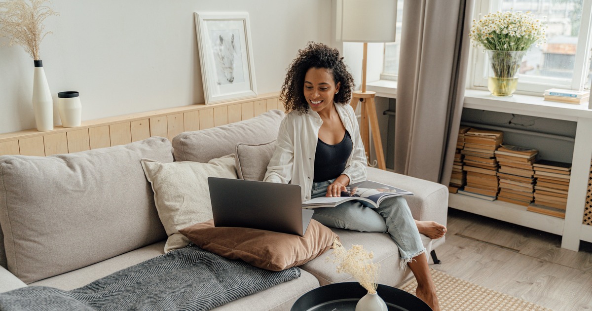 Writer sitting on couch with laptop