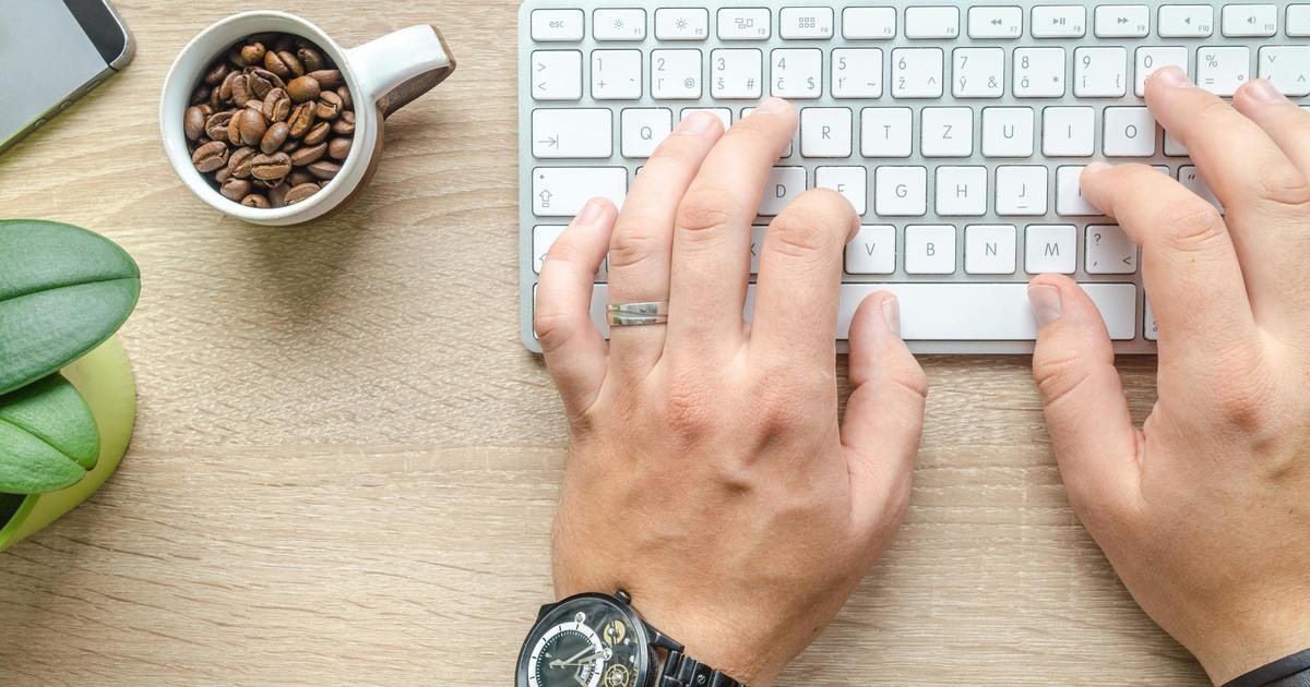 Writer typing on a laptop