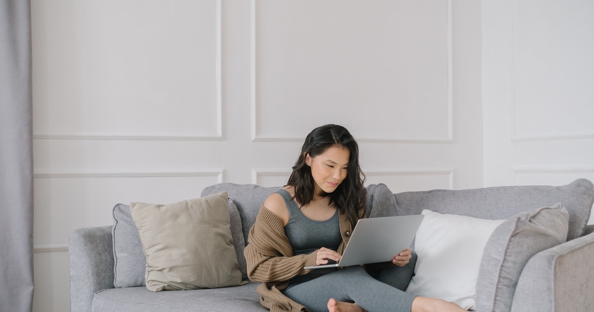 Writer sitting on the couch with laptop