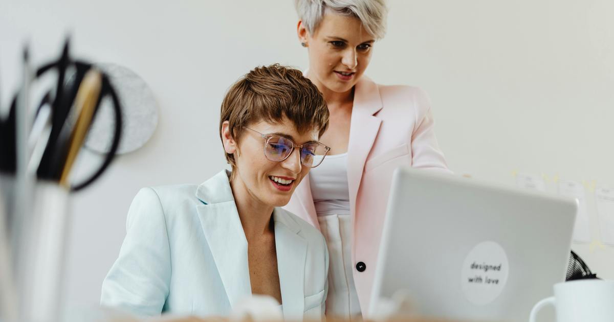 Two writers looking at a laptop