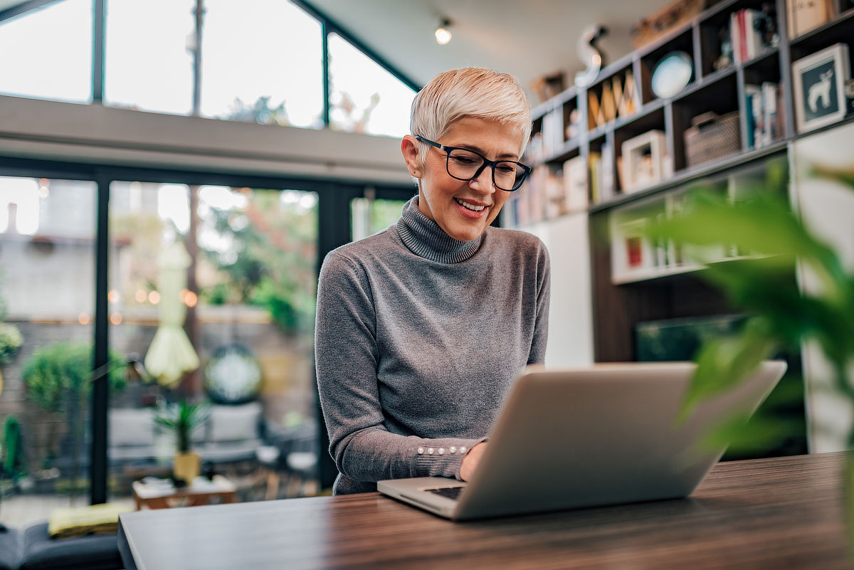 Woman writer working on laptop at home