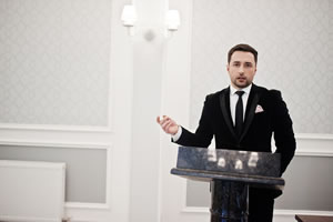 Man speaking behind a podium