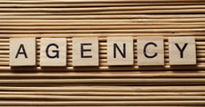 Wooden letter tiles spelling out the word Agency