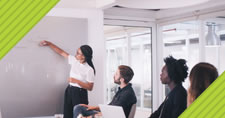 businesswoman in meeting presenting at whiteboard