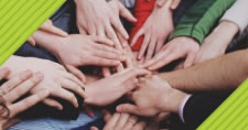 different people's hands stacked on top of one another