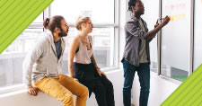 Photo of two business people watching a man giving a presentation and blue text box with the words Four Ways to Elevate Your Value as a Writer